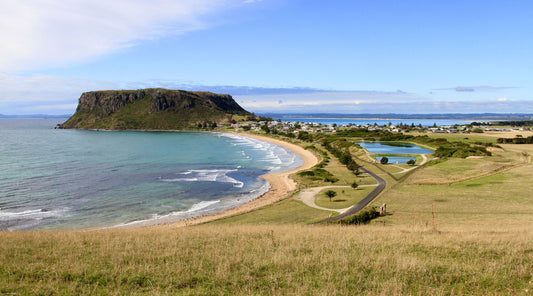 A huge round lump of Basalt called The Nut with the beach | Coastline of Tasmania