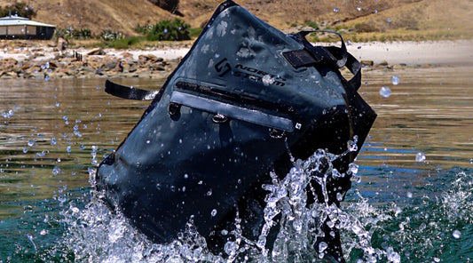 A North Storm waterproof backpack splashing in the water.