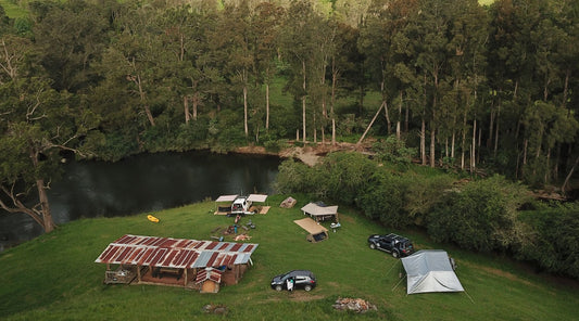 The lush campsite with bush and river at BOSSBERRIES AT DORRIGO